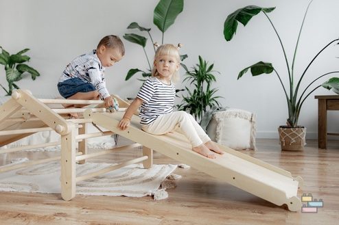 Triangle de Pikler pliable avec des enfants jouant dessus